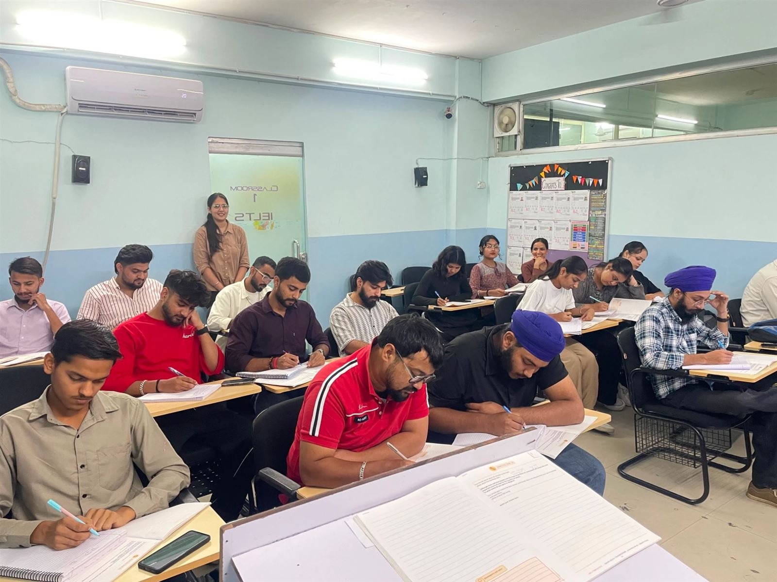 Students preparing for IELTS in an IELTS Simulator classroom